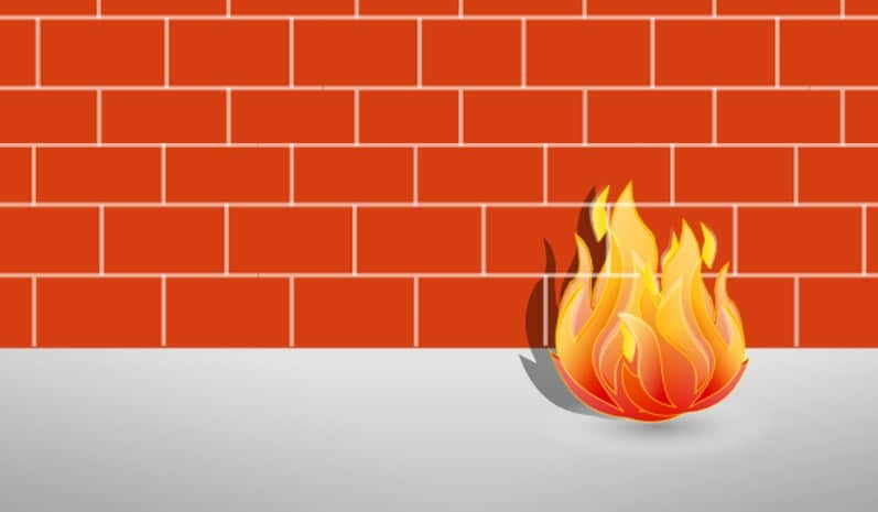 Old fashioned firewall representation of a fire in front of a red brick wall